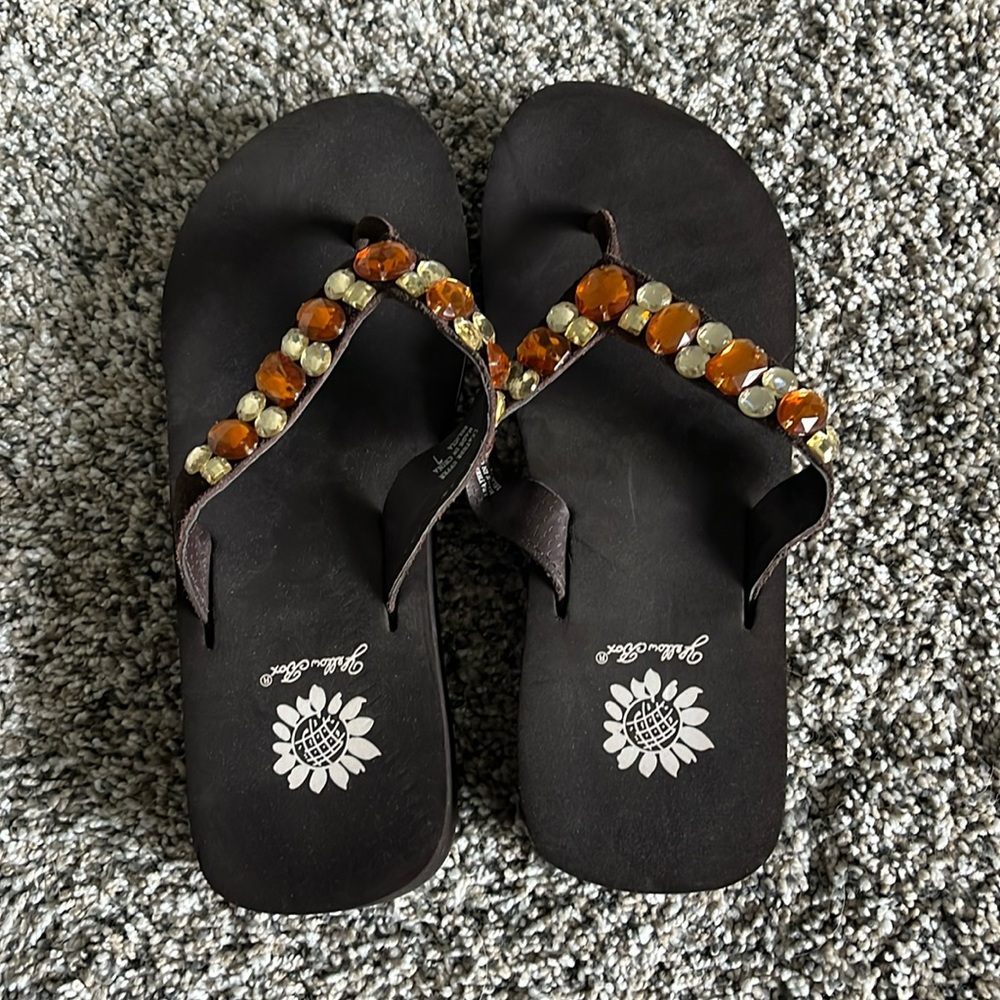 Yellow box rhinestone flip flops.